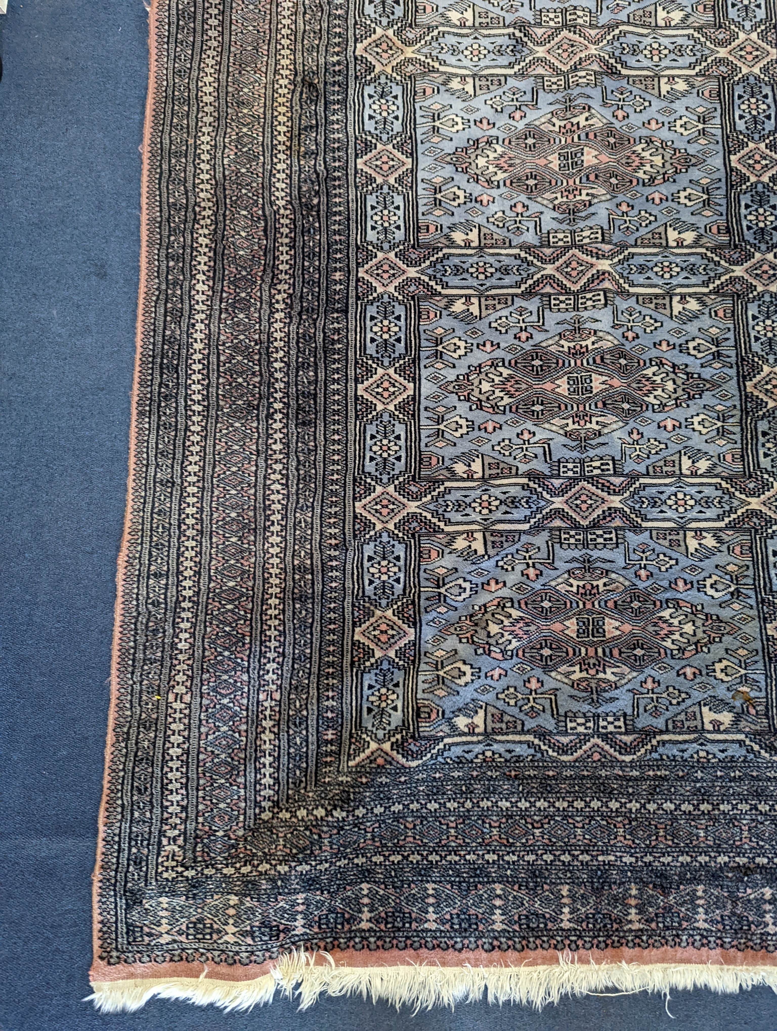 A Bokhara blue ground rug, 190 x 30cm
